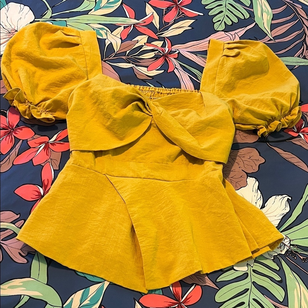 Mustard yellow smocked top with balloon short sleeves and peplum